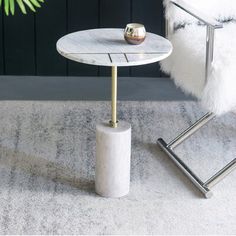 a white marble table sitting on top of a rug