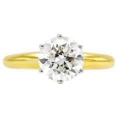 Finely crafted in 18k yellow and white gold with an Old European cut diamond weighing 1.77 carats. K color, VS1 clarity Size 6, resizable