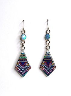 "Brand new high quality handcrafted earrings with genuine natural multicolor inlay stones on 925 sterling silver and stamped 925. The stones consist of Spiny oyster, Lapis, Fire Opal, coral and Mother of Pearl. Our silver is genuine 925 sterling silver. The earrings measures 2.5\" long and 3/4'' wide. The round stone on the top are 6mm. You will receive the item in a gift box Thanks for looking and check out more items in my Etsy shop for more great items and deals! https://www.etsy.com/shop/925 Iridescent Sterling Silver Dangle Earrings, Bohemian Multi-stone Dangle Earrings, Multicolor Multi-stone Teardrop Earrings, Bohemian Multicolor Multi-stone Earrings, Artisan Multicolor Long Drop Jewelry, Southwestern Style Multicolor Nickel-free Jewelry, Southwestern Multicolor Teardrop Earrings, Iridescent Sterling Silver Bohemian Jewelry, Sterling Silver Multi-stone Teardrop Earrings