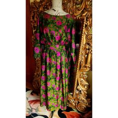 This elegant dress is from the 70's and was custom made for it's original owner. Made of a luxurious Dupioni Silk. Deep green back ground with hot pink floral print.  Blouson top tha sits at the edge of the shoulders. Nipped waist and slightly full long skirt.  Fully lined in olive green silk.  This is expertly made and excellent condition. Best fit would be a Medium, however, please see the measurements below for a proper fit. All sales are final. Measurements Armpit-armpit doubled 40" Waist 28" Hip 48" Length 54" 1970s Green Floral Print Dress, 1970s Style Green Floral Print Dress, Vintage Silk Dress With Floral Print, Retro Pink Silk Dress, Pink Silk Retro Dress, Pink Retro Silk Dress, Blouson Top, Hot Pink Floral, Dupioni Silk