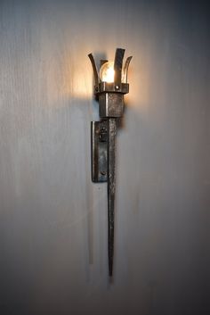 an old fashioned wall light on a white wall