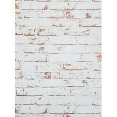 an old white brick wall with rusted paint