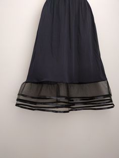 "An exquisite accessory for your wardrobe, this underskirt slip worn with your skirt or dress will make you feel very special ! It is made of black nylon with elastic waistband and three-tiered brown chocolate tulle ruffle 6\" long trimmed with 2 yards of satin ribbon. Standard length is 25\" and petite is 21\". This accessory makes a perfect gift! Hand wash in cold water. Available in color: 1-Brown 2-Black, 3-White, 4-Cream 5-Orange 6-Turquoise 7-Purple 8-Royal Blue 9-Navy 10-Bright Pink 11-Ye Elegant Sheer Tiered Skirt, Tiered Ruffled Skirt Petticoat For Evening, Evening Tiered Ruffled Skirt Petticoat, Evening Ruffled Tiered Petticoat, Evening Tiered Ruffled Petticoat, Elegant Tiered Skirt Party Petticoat, Elegant Tiered Skirt Petticoat For Party, Elegant Tiered Petticoat For Party, Elegant Tiered Party Petticoat