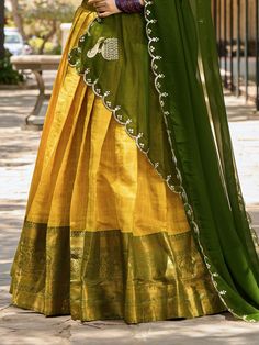 This exquisite ensemble includes a yellow color kanchipuram silk south indian half saree lehenga with intricate zari weaving work, a yellow color kanchipuram silk choli also with zari weaving work, and a green georgette dupatta with sequins embroidery lace borderwork. The lehenga is stitched up to 42 inches with a 3.80-meter flair, while the un-stitched choli material measures 1 meter. The length of the lehenga is 42 inches, and the dupatta is 2.5 meters long.
Drape yourself in this beautiful ye South Indian Half Saree, Indian Half Saree, Silk Half Saree, Lehenga Crop Top, Half Saree Lehenga, Lehenga Choli Wedding, Floral Lehenga, Party Wear Lehenga Choli, Reception Gown