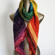 a multicolored knitted scarf on a mannequin headdress for display