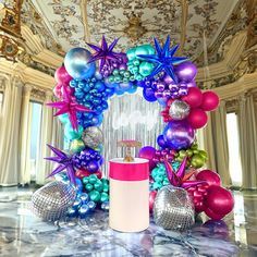 an elaborately decorated room with balloons and decorations