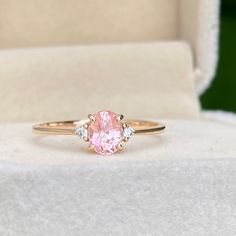 This elegant sapphire Ring featuring a 0.85ct Unheated & Untreated Natural Peach champagne Sapphire with two natural white diamonds Set in 14K solid Rose Gold, handcrafted in Sri Lanka.Main Stone : Natural Peach SapphireShape: OvalWeight: 0.85caratColor: Champagne PeachTreatment: NoneClarity : VSOrigin: Sri Lanka (Ceylon)Accent Stones: Natural White Diamonds (1.8mm)Metal: 14K Rose Gold (Available in Yellow Gold & White Gold, 18k Gold, Please get in touch with me ) Peach Champagne Sapphire, Champagne Sapphire, Peach Sapphire Rings, Victorian Style Rings, Oval Sapphire Ring, Emerald Earrings Drop, Peach Sapphire, Oval Engagement Ring, Oval Engagement