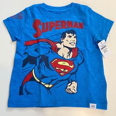 New With Tags. Special Edition Baby Gap Dc Superman Tshirt, Size 12-18 Months Gap Graphic Tee With Character Print, Blue Cotton T-shirt By Gap, Gap Cotton Tops With Character Print, Gap Blue Graphic Print Top, Blue Graphic Print Tops From Gap, Blue Graphic Print Gap Tops, Gap Cotton Tops With Logo Print, Gap Cotton Top With Cartoon Print, Gap Short Sleeve T-shirt With Character Print