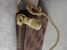 Overview Louis Vuitton Mini Pochettes Accessoires in Damier Ebene Canvas and gold hardware. The Mini Pochette Accessoires in Monogram canvas is a stylish way to carry essentials. Its secure zip protects a spacious compartment, while the chain and hook enable it to be attached to a larger bag, as well as carried in the hand. The rounded shape and supple canvas give this pouch a particularly pleasant feel. Can be carried in hand. Perfect for carrying cards and coins. 2020 year. Features Damier ebe Louis Vuitton Mini, 2020 Year, Vintage Clutch, Louis Vuitton Damier Ebene, Small Backpack, Damier Ebene, Carry All Bag, Vuitton Bag, Large Bag