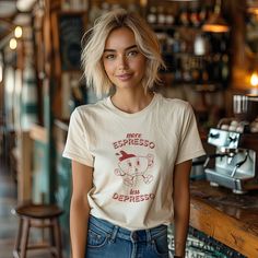 Brighten your wardrobe with our "More Espresso Less Depresso" T-shirt! This Retro Coffee TShirt features a vintage-style graphic designed for true coffee lovers. Made with soft, high-quality fabric, it offers the perfect blend of comfort and durability. Unisex and trendy, it's a great addition to any casual outfit. Ideal for coffee enthusiasts and those who appreciate a good laugh, this funny quote tee makes a thoughtful gift. Embrace the humor and style of your daily grind with this must-have shirt! UNVEILING OUR CLASSIC UNISEX JERSEY TEES: * Crafted with 100% Airlume combed and ring-spun cotton for that feather-light, breathable feel. Perfect for both hitting the gym and hitting the couch. * Each tee is printed with precision and care, ensuring every design lives up to our high standards Coffee Color Crew Neck T-shirt For Everyday, Coffee Color Short Sleeve T-shirt With Screen Print, Casual Coffee-colored Screen Print T-shirt, Coffee Color Relaxed Fit Short Sleeve T-shirt, Casual Coffee Pre-shrunk Tops, Casual Coffee Crew Neck T-shirt, Coffee Colored Short Sleeve T-shirt With Screen Print, Relaxed Fit Coffee Top With Funny Print, Coffee Short Sleeve T-shirt With Screen Print