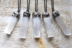 These are beautiful Selenite crystals wands that I purchased at a gem show and then hand soldered. A perfect gift for anyone who loves allure of natural stones.  You'll receive one Selenite, soldered necklace. Each one is about the same size of about 2 1/4" long and about 1/2 wide. They vary slightly as the chunky soldered tops are all unique. I've used a handmade stainless steel black chain with a dark patina on the aluminum for each pendant. I've given you the choice of length in the variation White Mystical Crystal Necklace Gift, White Mineral Crystal As Gift, Bohemian White Crystals For Gifts, Bohemian White Crystals As Gifts, Handmade White Mineral Crystal Necklaces, Handmade White Mineral Crystal Necklace, Bohemian Handmade White Crystals, Handmade Bohemian White Crystals, Handmade White Bohemian Crystals