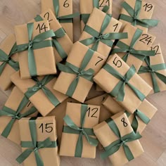 a pile of wrapped presents sitting on top of a wooden floor next to each other