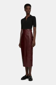 The Lorelei pencil skirt follows the Emilia Wickstead feminine tailoring, constructed from a supple leather in an oxblood tone. The Lorelei pencil skirt it cut to a high waist and is finished with a vent at the back. this skirt exudes sophistication and grace, offering both style and comfort for any occasion. Fitted Leather Pencil Skirt In Modern Style, Fitted Modern Leather Pencil Skirt, Modern Fitted Leather Pencil Skirt, Formal Fitted Leather Pencil Skirt, Chic Leather Pencil Skirt For Formal Occasions, Fitted Leather Pencil Skirt For Work, Fall Formal Leather Pencil Skirt, Elegant Leather Pencil Skirt For Work, Chic Burgundy Skirt For Work