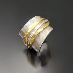 Gold & Silver Ring - A study in texture and contrast, this distinctive, hand-hammered ring pairs the cool shimmer of sterling silver with the warmth of 18k gold. Available in whole and half sizes 6 to 8.5. For pricing and availability of sizes outside of this range, please contact our customer care department.Care instructions. Polish with a silver polishing cloth. Luxury Hammered Wide Band Jewelry, White Gold Jewelry With Hammered Wide Band, Elegant Sterling Silver Hammered Wide Band Ring, Elegant Hammered Wide Band Ring In Sterling Silver, Modern Hammered Rings For Anniversary, Hammered Wide Band Open Ring For Anniversary, Anniversary Wide Band Ring With Hammered Open Design, Anniversary Hammered Wide Band Open Ring, Unique Hammered Wide Band Rings