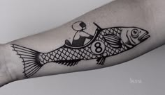 a fish tattoo on the left arm