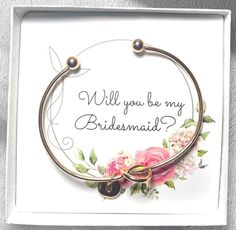 a card with the words will you be my bridesmaid? on it and flowers