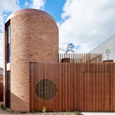 a brick building with a circular window on the side