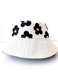 Flower Bucket Hat, White Bucket Hat, Handmade, Handpainted Fashionable and comfortable bucket hat head accessory. Perfect for covering the face and eyes from sun All hats are painted by hand so there might be some ever-so-slight differences (maybe a thicker/thinner brush stroke in some spots) No screen printing or vinyl transfers, it's all made from the heart baby :) Each of these handmade hats is personally sewn and handpainted.  You can also combine your bucket hat with a trendy bag to create Adjustable Natural Bucket Hat, Adjustable Natural Color Bucket Hat, Reversible White Sun Hat For The Beach, White Reversible Sun Hat For The Beach, White Reversible Sun Hat For Beach, Summer Bucket Sun Hat For Spring, Casual Natural Color Bucket Sun Hat, Adjustable Bucket Sun Hat For Spring, Adjustable Bucket Shape Sun Hat For Spring