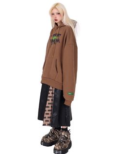 Oversized hoodie in a rich brown color with a street-inspired graffiti-style logo print on the chest. Features a roomy kangaroo pocket and an adjustable drawstring hood. The logo combines black and neon green colors for a bold contrast against the brown fabric. Relaxed fit with dropped shoulders for a casual, urban look. Model info Height: 160cm Weight: 43kg Wearing size: M Oversized Graffiti Print Hoodie For Fall, Brown Streetwear Sweatshirt With Pockets, Oversized Winter Hoodie With Graffiti Print, Brown Urban Winter Sweatshirt, Casual Oversized Hoodie With Graffiti Print, Brown Graphic Print Sweatshirt For Streetwear, Oversized Brown Hoodie Sweatshirt, Brown Oversized Hooded Sweatshirt, Oversized Brown Hooded Sweatshirt