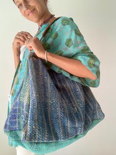 a woman is holding a large bag in her hands