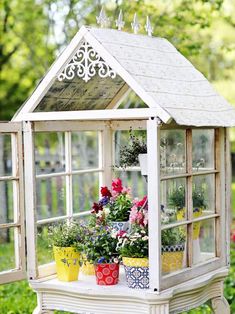 an old window is used as a potting shed for flower pots and other plants