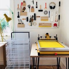 a room with two tables and some type of equipment on the wall behind each table