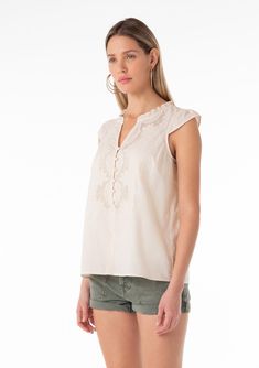 A cotton short sleeve bohemian spring top with embroidered detail. Cotton Embroidered Relaxed fit Short cap sleeve Hip length Split v-neckline Ruffled neckline Self-covered button front Lined Bohemian spring top Delicate embroidered details add a bohemian touch to this elevated cap-sleeve blouse. Featuring a self-covered button front and a split v-neckline. Perfect for spring and summer, we love to style this top with shorts and flat sandals. Model is 5'9, wearing a size S.Style: I-15069WL-SGI Casual Short Sleeve Embroidered Summer Top, Feminine Summer Tops With Split Neck, Cotton V-neck Blouse With Embroidered Hem, Cotton Split Neck Top For Summer, Casual V-neck Blouse With Embroidered Hem, Bohemian Cotton V-neck Top, Vacation V-neck Blouse With Embroidered Hem, V-neck Tops With Embroidered Hem, Summer Split Neck Tops