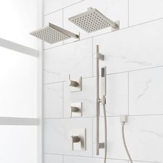 the shower head and hand shower faucet are shown in this white tiled bathroom