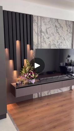 a living room filled with furniture and a flat screen tv on top of a wooden floor