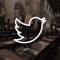 a large room filled with tables and chairs covered in white paper birds flying over them