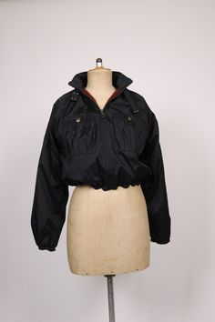 "➸ Description: Beautiful and extremely rare 90's bomber jacket by Jean-Paul Gaultier. Featuring a black nylon outer fabric, burgundy wool lining, long sleeves, frontal zip and ribbed collar and waistband trim. One of Gaultier's most iconic themes. Condition: excellent ➸Measurements: Shoulder 16''-17'' / Sleeves 24''-25'' / Bust 21'' / Waist 14''-19'' / Length 18''-19'' Visit my instagram @bazvintage Note: - You are welcome to contact me and ask me anything - I sell vintage and antique pre-owned Vintage Black Windbreaker For Winter, Black Vintage Track Jacket For Fall, Vintage Black Nylon Windbreaker, Wool Winter, Ask Me Anything, Paul Gaultier, Black Nylon, Jean Paul, Jean Paul Gaultier