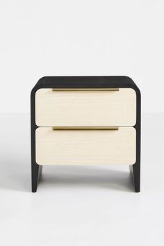 a black and white nightstand with two drawers on each side, against a white background