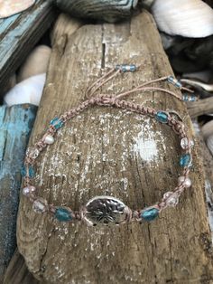 "Here is a lovely sea inspired anklet. The colors are so pretty together and the colors will remind any beach lover of the sea. This makes a perfect gift for yourself, friend or loved one:) Pictured is a hand knotted macrame style sand dollar anklet designed on waterproof polyester cord in beige with small turquoise and clear glass and light pink pearls. I allow about 3\" to 4\" extra inches so you can slide your anklet easily over your foot and it closes with an adjustable slide knot; no clasps Adjustable Silver Anklets For Vacation, Bohemian Adjustable Anklets For Beach, Silver Adjustable Anklets For Vacation, Beach Anklets With Adjustable Length, Adjustable Silver Anklets For Beach Season, Adjustable Anklets With Round Beads For Beach, Adjustable Round Beads Anklets For Beach, Handmade Adjustable Ocean-inspired Anklets, Adjustable Beaded Beachy Anklets