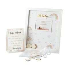 a baby's birth gift set with coins and a card