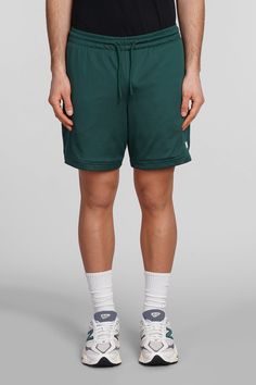 Shorts in green polyester, elasticated waistband, coulisse closure, perfored, side logo print, Made in Cambodia, Model is 1. 83 and wears size M Green Drawstring Bottoms For Streetwear, Green Moisture-wicking Sportswear Bottoms, Green Nylon Bottoms With Elastic Waistband, Green Sports Shorts With Elastic Waistband, Green Bottoms With Elastic Waistband For Streetwear, Green Nylon Sportswear Shorts, Green Sports Bottoms With Elastic Waistband, Green Nylon Athletic Shorts With Elastic Waistband, Green Athletic Shorts With Elastic Waistband For Sports