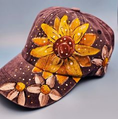 a brown hat with yellow flowers painted on it