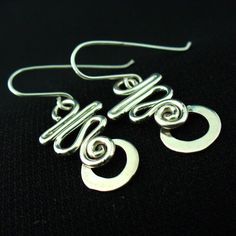 These earrings are hand crafted in solid sterling silver.I use 16 gauge wire for these so they're nice and light but not flimsy.For a unique,long lasting and clearly handmade pair of everyday dangles that won't break the bank.These will do the trick. Everyday Sterling Silver Wire Wrapped Jewelry, Modern Adjustable Sterling Silver Wrap Earrings, Adjustable Hypoallergenic Sterling Silver Wrap Earrings, Handmade Spiral Sterling Silver Wrap Earrings, Modern Handmade Sterling Silver Hoop Earrings, Minimalist Spiral Hoop Earrings In Sterling Silver, Minimalist Spiral Sterling Silver Hoop Earrings, Unique Sterling Silver Pierced Wrap Earrings, Modern Sterling Silver Nickel-free Linear Earrings