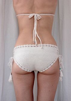 the back of a woman's panties with white crochet and tassels