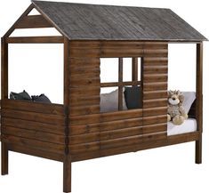 a small wooden cabin bed with a stuffed animal