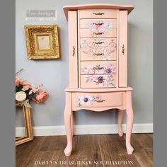 a pink dresser with flowers painted on it