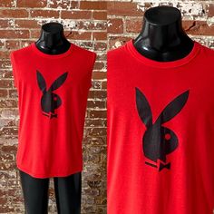 *1980s Cherry Red Playboy Bunny Box Tee *Vintage 80s Playboy Bunny Logo Graphic Sleeveless T-Shirt Notes: *Good vintage condition; faint black line upper chest/shoulder area above graphic - pictured; material pilled here and there *Single stitch Sundancer tee; 50% Cotton 50% Polyester; made in Canada; tag size XL *Fits like men's size Large Measurements: Pit to pit: 21.25"  Length, shoulder to bottom: 28.5"  *Item is vintage and sold as is *Feel free to message me for any additional details  *Pl Vintage Sleeveless T-shirt With Graphic Print, Retro Crew Neck Tank Top With Graphic Print, Vintage Tank Top For Spring Streetwear, Vintage Crew Neck Muscle Tee For Summer, Retro Graphic Print Sleeveless Tank Top, Retro Red Sleeveless Tank Top, Vintage Cotton Muscle Tee, Vintage Tank Top For Streetwear, Vintage Sleeveless Graphic Print T-shirt