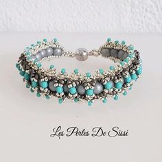 the beaded bracelet is made with silver and turquoise beads, which are strung together