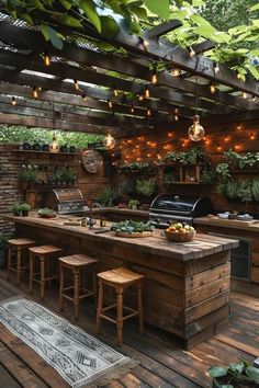 an outdoor kitchen with lots of plants and lights