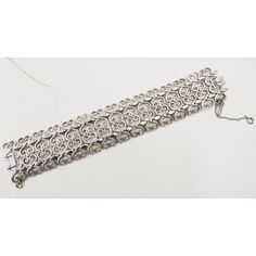 This is part of Chairish’s Costume Jewelry assortment.  Rhodium plated filigree open work bracelet with fold over clasp and security chain. Marked "Monet." Measures: 7 3/4 inches long by 1 3/8 inches wide. From Monet's 1965 Mantilla line. The matching necklace and earrings are shown on pg. 200 of Alice Vega's book "Monet; The Master Jewelers." Excellent condition.  Please reference the measurements noted in the description above for the best approximate dimensions. Please reach out to the seller Ornate Nickel-free Bracelet, Ornate Hallmarked Sterling Silver Bracelet, Monet Jewelry Vintage, Luxury Victorian Hallmarked Sterling Silver Bracelet, Monet Jewelry, Vintage Monet, Modern Branding, Necklace And Earrings, Fold Over