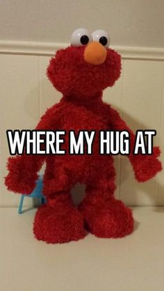 a red stuffed animal with the caption where my hug at is on it's chest