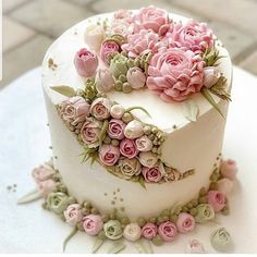 a white cake with pink flowers on it