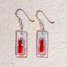 pair of earrings with red and white glass in the shape of rectangular rectangles