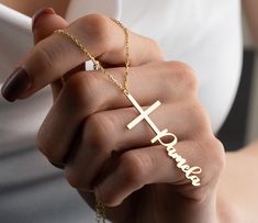 "Cross Name Necklace The name cross necklace is a beautiful and personalized piece of jewelry that combines the timeless symbol of Christianity with the wearer's name or initials. It is a perfect religious gift for special occasions such as baptisms, confirmations, and weddings. For mothers who wish to keep their faith close to their hearts, the name cross necklace can be a thoughtful and meaningful gift. It serves as a daily reminder of the love that God has for their family and the importance Personalized Cross Pendant Jewelry For Mother's Day, Personalized Cross Pendant Jewelry Gift, Personalized Cross Pendant Jewelry For Gifts, Personalized Cross Jewelry For Mother's Day, Personalized Elegant Cross Necklace, Elegant Personalized Cross Necklace, Cross-shaped Name Jewelry For Anniversary, Name-engraved Cross Jewelry For Anniversary, Anniversary Jewelry With Name And Cross Shape