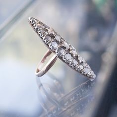 A French 19th century navette ring with imperfectly perfect table and rose cut diamonds set in silver and 12k yellow gold that bears two unidentified makers marks. Currently a size 5.5 and resizable, so leave a note at checkout with the size you need (click "add note")! All vintage is final sale! If you have any questions, please email info@fiatluxsf.com prior to purchase. Victorian Oval Diamond Ring With Rose Cut Diamonds, Antique Marquise Rose Cut Diamond Jewelry, Victorian Marquise Diamond Ring With Single Cut Diamonds, Antique Marquise Rings With Rose Cut Diamonds, Victorian Rose Cut Marquise Diamond Jewelry, Antique Marquise Silver Rings, Antique Marquise Rose Cut Diamond Ring, Victorian Marquise Cut Diamond Ring, Vintage Marquise Rose Cut Diamond Ring