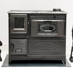 an old fashioned stove sitting on top of a table